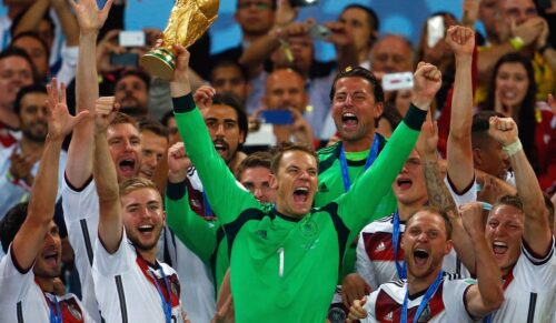 RIO DE JANEIRO, BRAZIL - JULY 13:  Manuel Neuer of Germany lifts the World Cup trophy with teammates after defeating Argentina 1-0 in extra time during the 2014 FIFA World Cup Brazil Final match between Germany and Argentina at Maracana on July 13, 2014 in Rio de Janeiro, Brazil.  (Photo by Clive Rose/Getty Images)