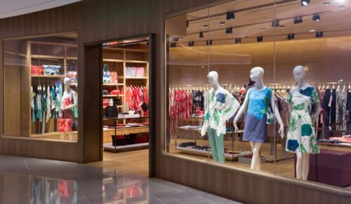 Boutique display window with mannequins in fashionable dresses 